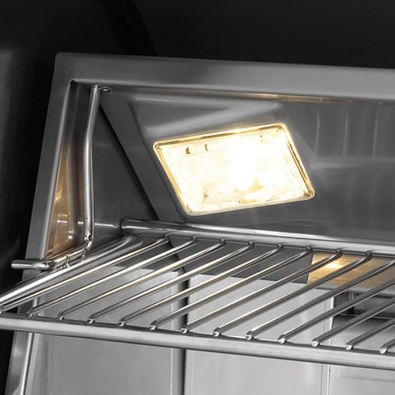 Interior view of a refrigerator shelf with a bright overhead light, showcasing stainless steel construction and wire rack design.