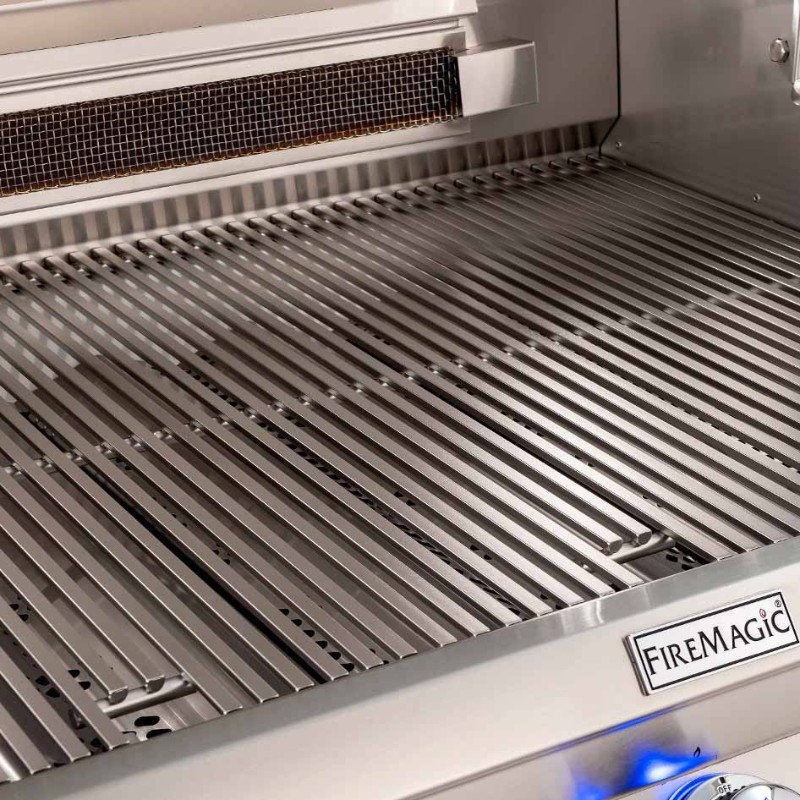 High-quality stainless steel grill grates of a Fire Magic outdoor grill, showcasing a clean and spacious cooking surface ideal for barbecuing.