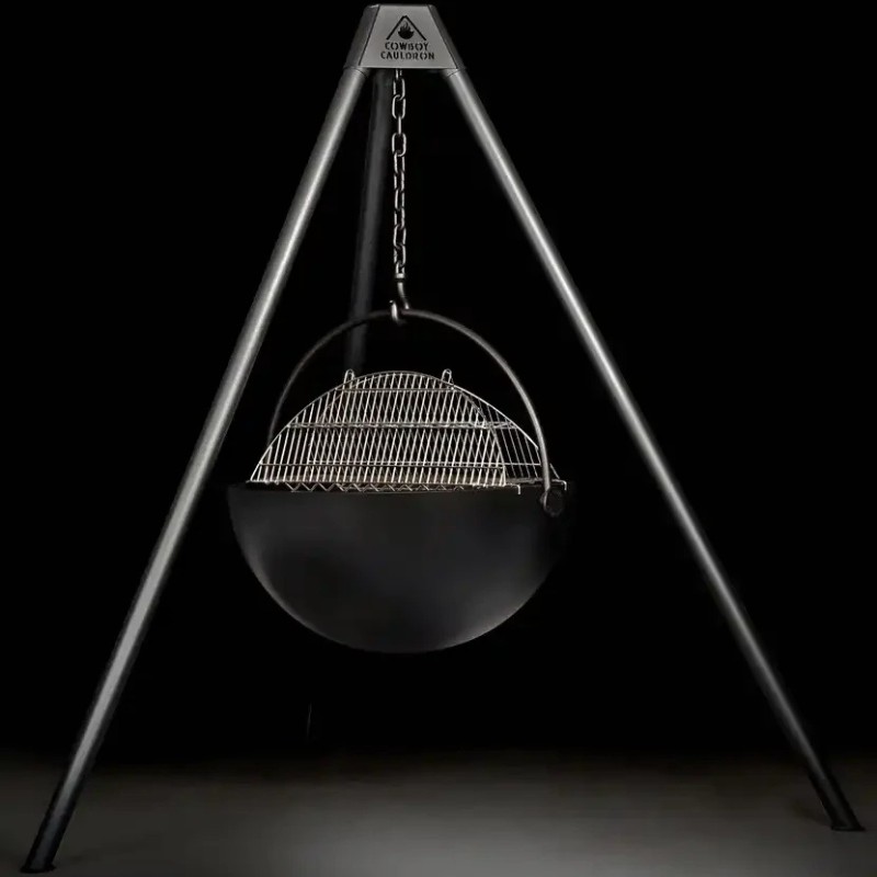 Heavy-duty tripod grill with a black cauldron base and stainless steel cooking grate, designed for outdoor cooking.