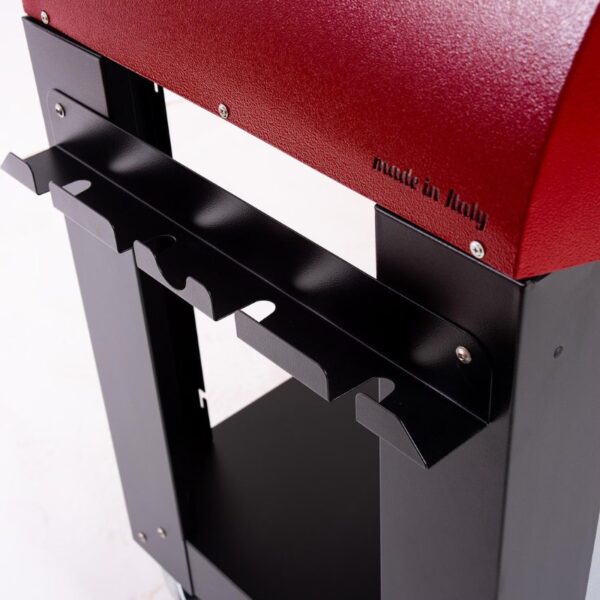 Close-up of a stylish black and red metal stand with a wine bottle holder, featuring a 'made in Italy' label, designed for functional elegance in home décor.