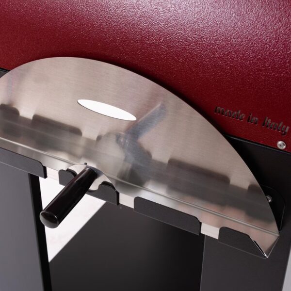 Stainless steel component of a machine with a black handle, featuring a curved design and a textured red background, labeled "made in Italy."