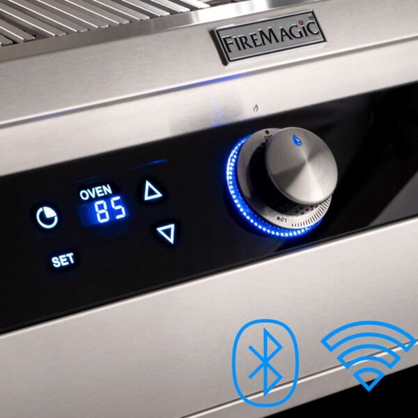 Close-up of a FireMagic grill control panel featuring an oven temperature display set to 85°F, illuminated buttons, and icons for Bluetooth and Wi-Fi connectivity.