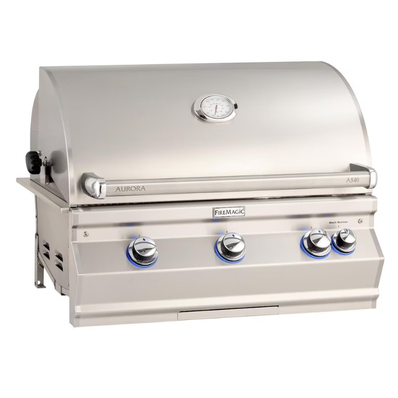 Stainless steel Fire Magic A540 gas grill featuring four control knobs, a built-in thermometer, and blue LED lighting for modern outdoor cooking.