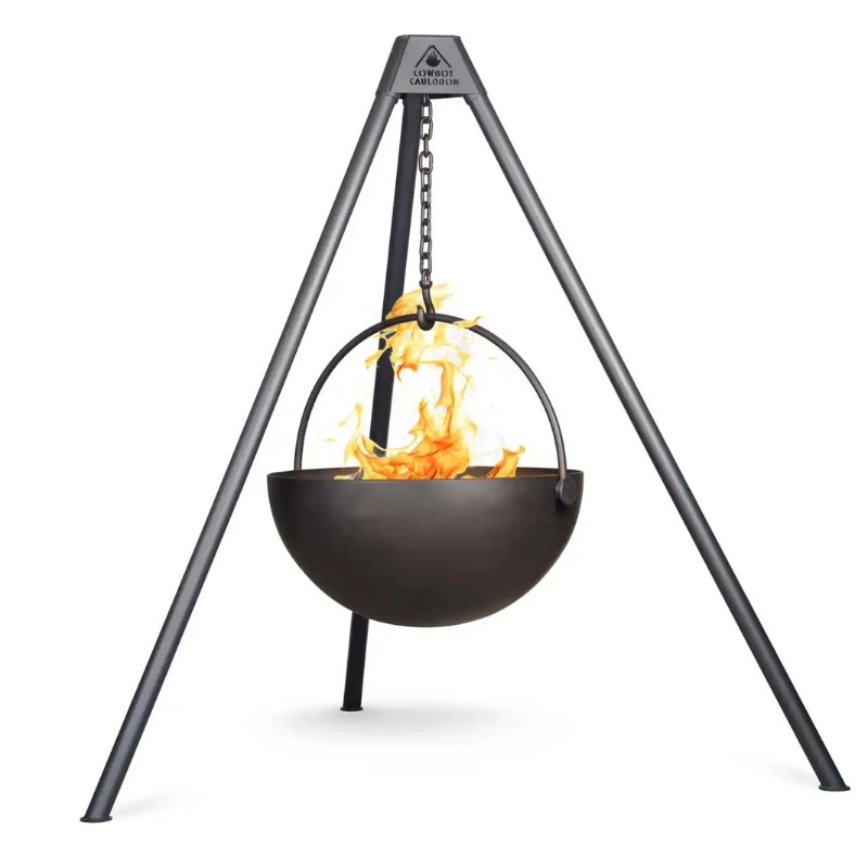 Black cauldron suspended over a fire pit, supported by a sturdy tripod frame, ideal for outdoor cooking and camping.