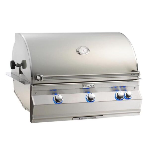 Stainless steel Fire Magic A790 gas grill with three blue-lit knobs and a built-in thermometer on a rounded lid.