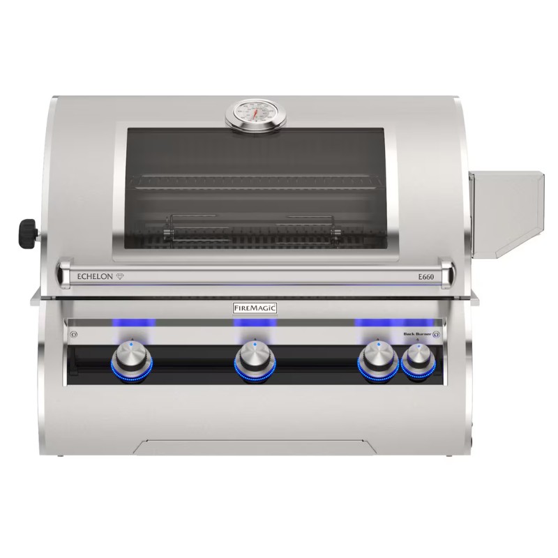 Stainless steel Fire Magic Echelon E660 gas grill with three control knobs, a built-in thermometer, and a glass lid for easy monitoring. Ideal for outdoor cooking and barbecues.