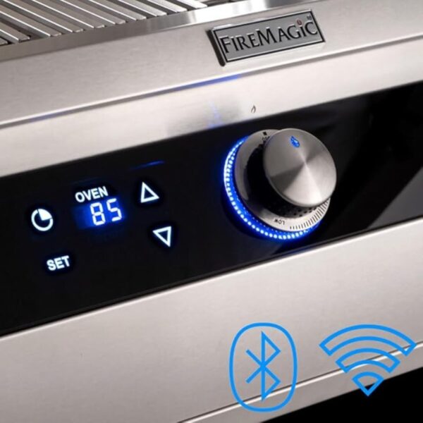 Close-up of a FireMagic grill control panel featuring an oven temperature display set to 85°F, illuminated buttons, and Bluetooth and Wi-Fi icons for connectivity options.