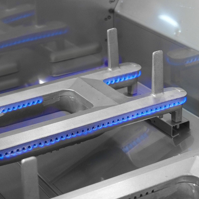 Close-up of a silver metallic gas stove burner with blue flames, highlighting its modern design and functionality.