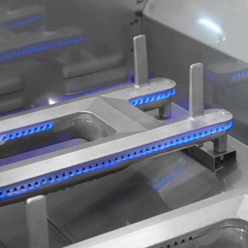 Close-up view of a high-tech cooking appliance featuring metallic components with blue LED lighting, showcasing a modern design for enhanced cooking efficiency.