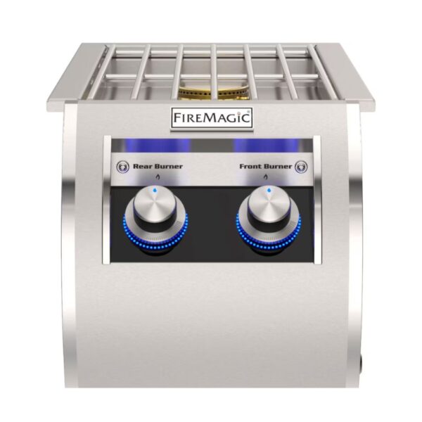 Stainless steel Fire Magic grill featuring front and rear burner controls with illuminated knobs.