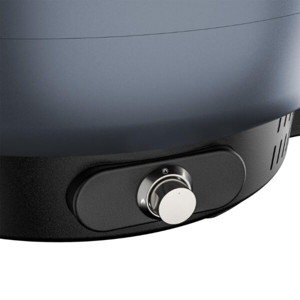 Close-up of a modern cooking appliance featuring a sleek grey body and a circular control knob for adjusting settings.