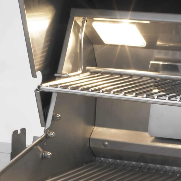 Interior view of a stainless steel grill featuring a lit compartment and a slatted cooking rack.