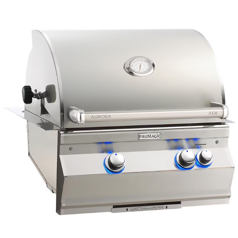 Stainless steel Fire Magic Aurora A430 gas grill with a dome lid and temperature gauge, featuring illuminated control knobs and a stylish design for outdoor cooking.