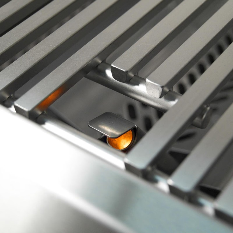Close-up of a stainless steel grill with illuminated burners, showcasing the grill grates and ignition mechanism.