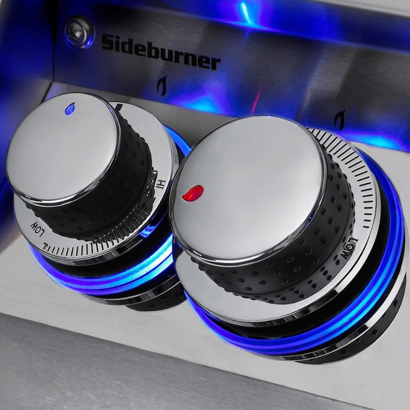 Close-up of a stainless steel sideburner with chrome knobs featuring blue LED lights, indicating low and high heat settings for grilling.