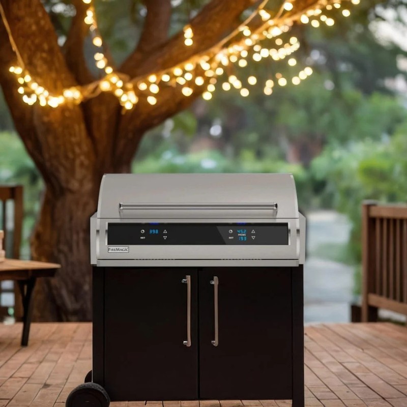 Stylish outdoor grill with digital temperature controls, set on a wooden deck adorned with fairy lights, surrounded by greenery.