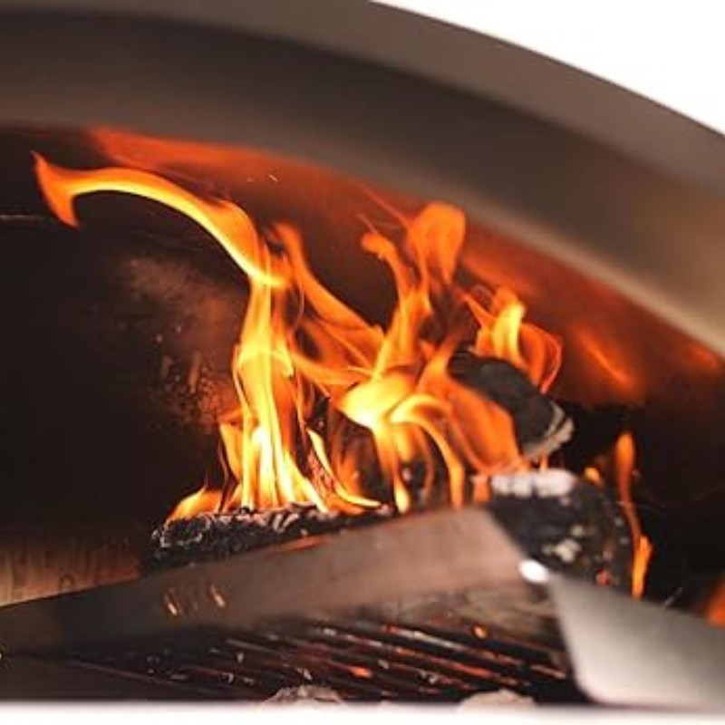 Flames dancing in a pizza oven with glowing embers, showcasing the intense heat for cooking.