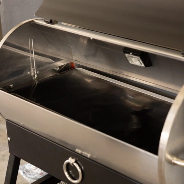 Stainless steel grill with an open lid, featuring two temperature probes and a black cooking surface, designed for outdoor cooking.