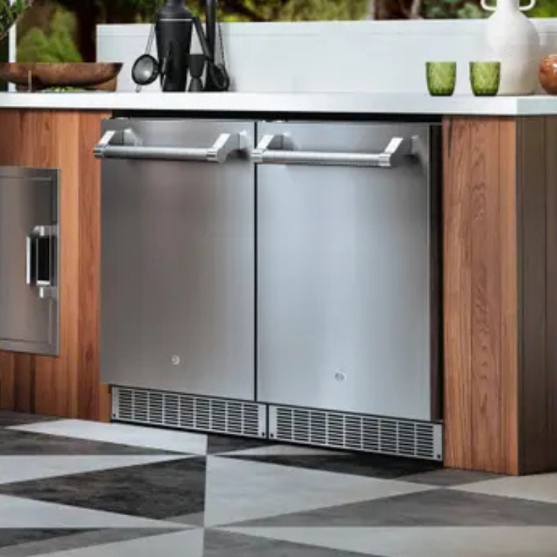 Stainless steel outdoor refrigerator with double doors installed in a wooden kitchen cabinet, featuring modern design and sleek lines.