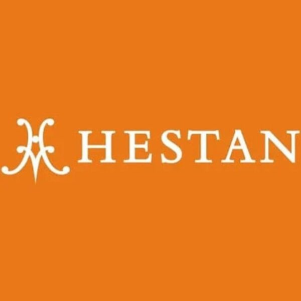 Hestan logo on an orange background, featuring stylized letters and an elegant design.