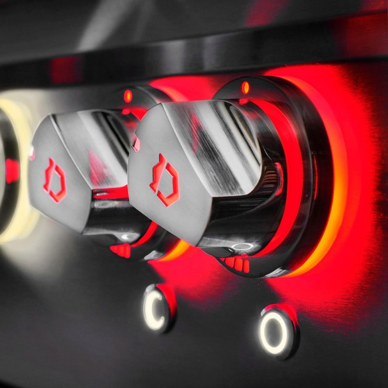 Close-up of modern stainless steel control knobs with red backlighting, designed for a sleek kitchen appliance.