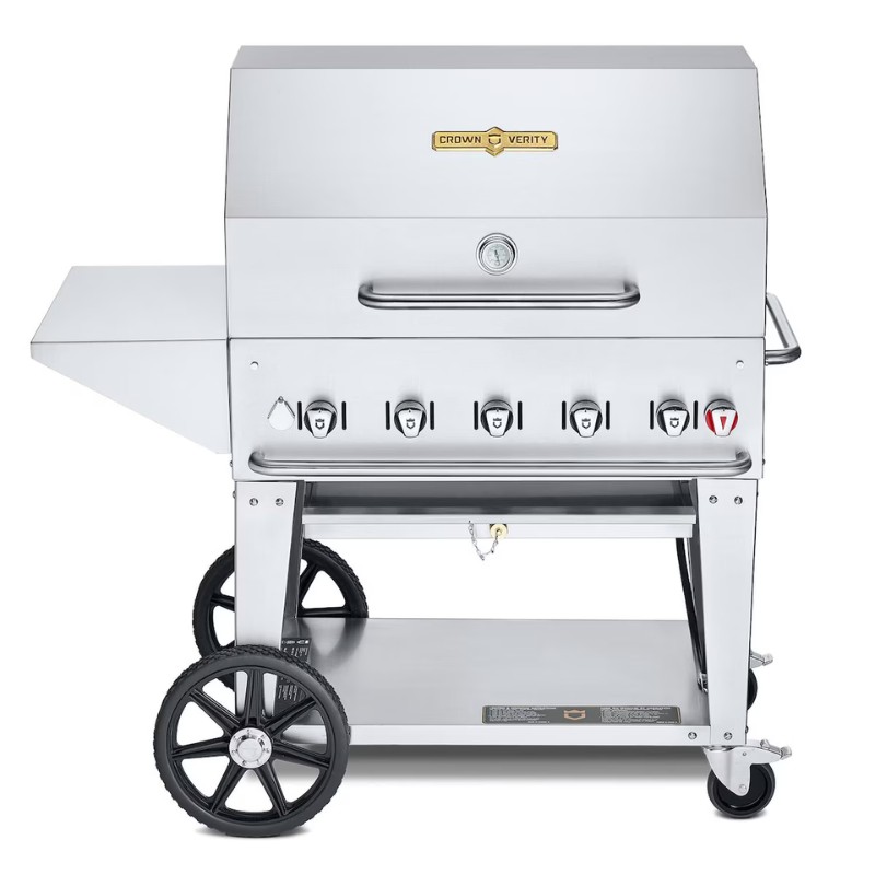 1c349fc1-3a97-4a8c-960a-bfb346bd626f.jpg Stainless steel commercial gas grill with multiple burners and a side shelf, featuring large wheels for mobility.