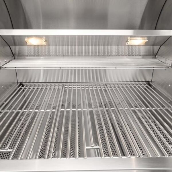 Interior view of a stainless steel outdoor grill, featuring multiple cooking grates and built-in lighting for enhanced visibility.