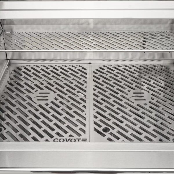 Stainless steel grill interior featuring a patterned grate design with Coyote branding, ideal for outdoor cooking.