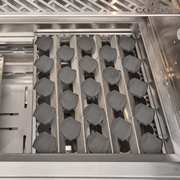 Close-up of a stainless steel grill with evenly arranged charcoal briquettes, designed for efficient heat distribution and cooking.