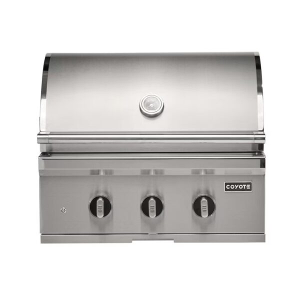 Stainless steel Coyote gas grill with three control knobs and a built-in thermometer, designed for outdoor cooking.