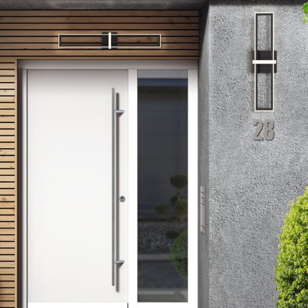 Modern entrance door with a sleek design, wooden slat accents above, wall-mounted light fixture, and house number 28 displayed on textured gray wall, complemented by well-maintained greenery.