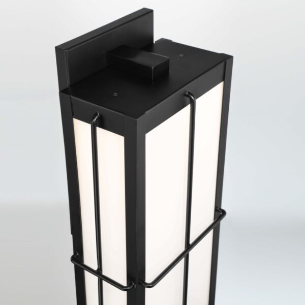 Modern black and white floor lamp with a minimalist design, featuring a rectangular shape and sleek metal detailing.