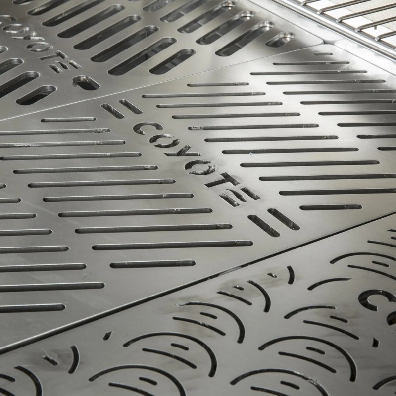 Close-up of a stainless steel grill surface featuring the Coyote brand logo and slotted design for optimal heat distribution and cooking efficiency.