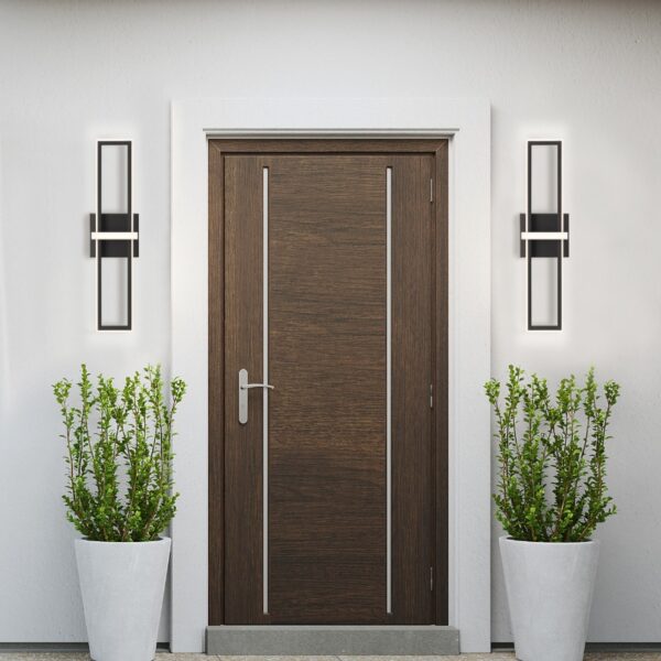 Modern wooden front door with vertical panels, stylish wall sconces, and potted greenery on a white exterior wall.
