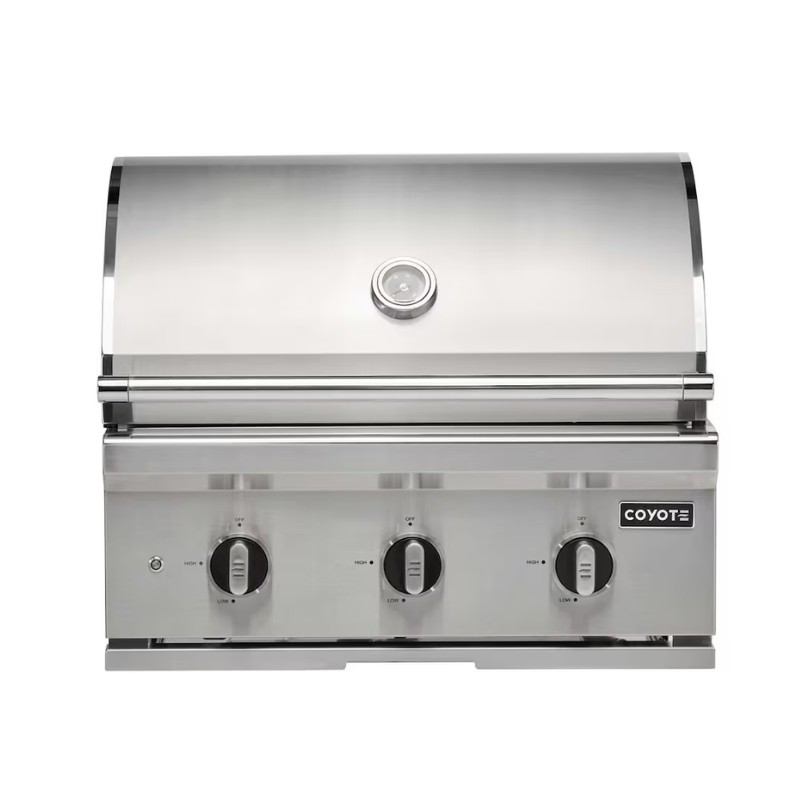 Stainless steel Coyote grill with three control knobs and a thermometer, designed for outdoor cooking.