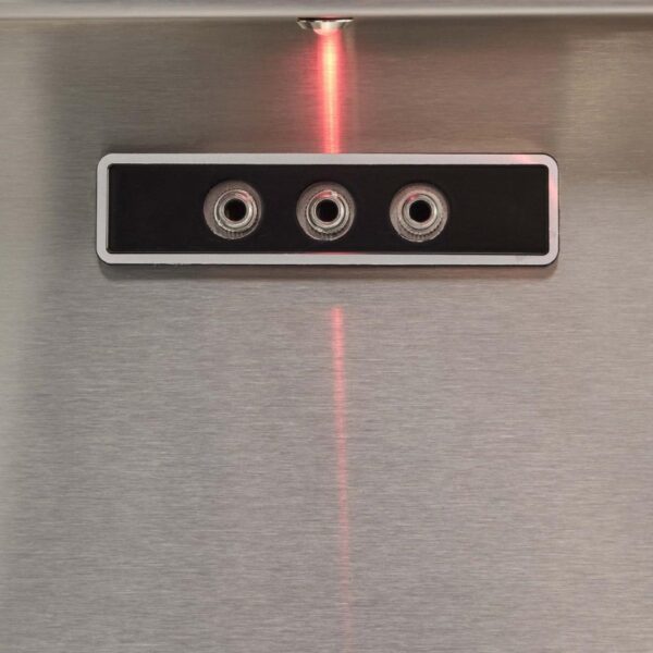 Close-up of a stainless steel panel featuring three audio jacks, with a red indicator light above.
