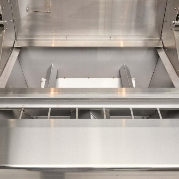 Interior view of a stainless steel appliance featuring a spacious compartment and a slotted tray for efficient organization and storage.