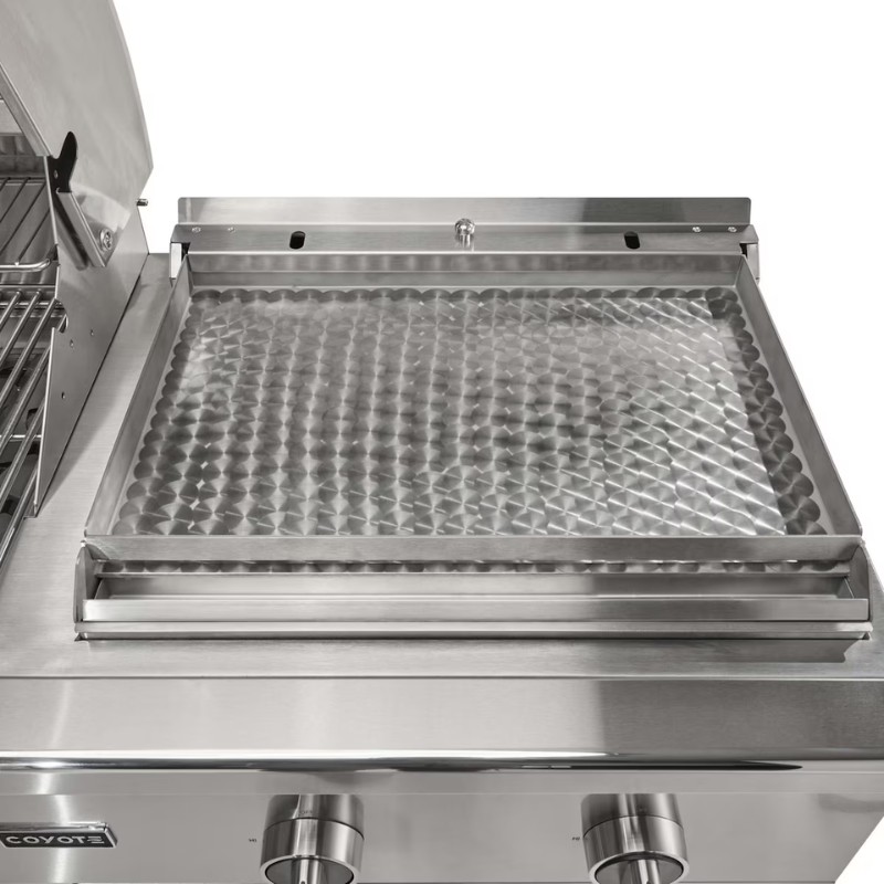 Stainless steel grill with a textured cooking surface and control knobs, designed for outdoor cooking.