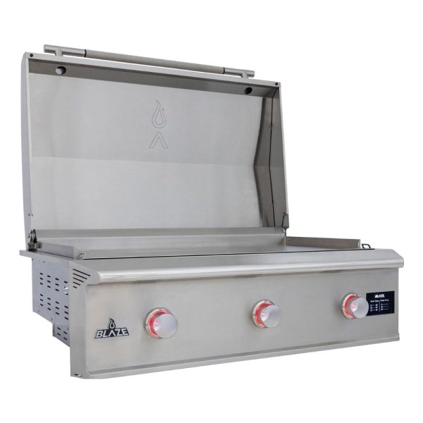 Stainless steel outdoor grill with three burners and an open lid, showcasing its spacious cooking area and control knobs.