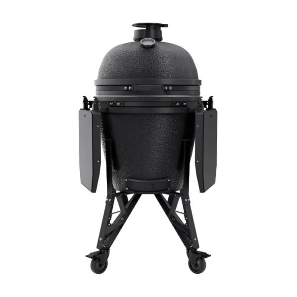 Black ceramic kamado grill with a sturdy stand and side shelves, featuring a temperature gauge on top and wheels for mobility.