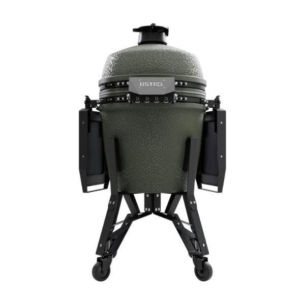 Green ceramic kamado grill on a sturdy black stand with wheels, featuring side shelves for convenience and a sleek design.