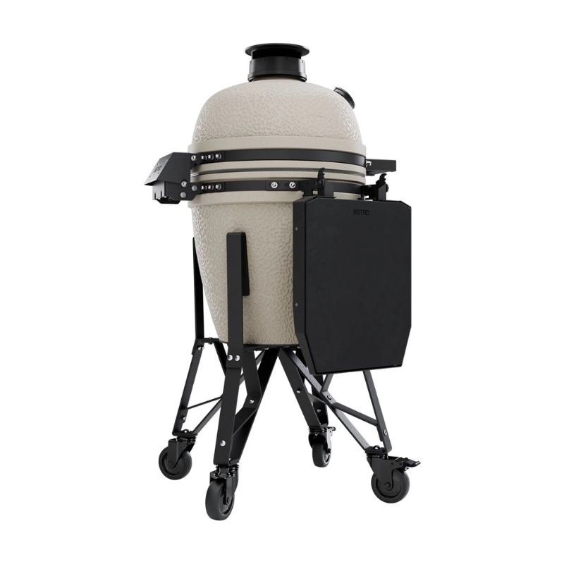 4c3d9d2f-1e28-49be-9311-00f3a1ebdb9a.jpg Ceramic kamado grill on a mobile cart with a black side shelf, featuring a textured finish and adjustable vent.