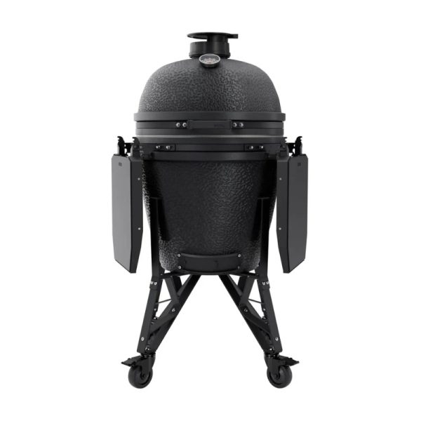Black ceramic grill with a dome shape, featuring side shelves and a built-in thermometer, mounted on a wheeled stand for easy mobility.