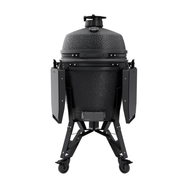 Black ceramic kamado grill on a sturdy wheeled stand, featuring adjustable air vents and side shelves for convenience.