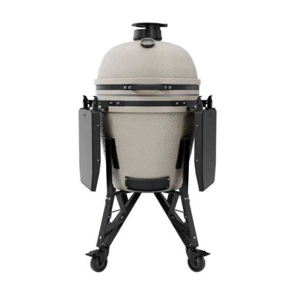Ceramic charcoal grill on a sturdy black cart with side shelves, designed for versatile outdoor cooking.