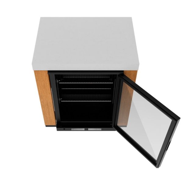 Compact under-counter refrigerator with a glass door, wooden side panels, and a light-colored countertop, showcasing interior shelving.