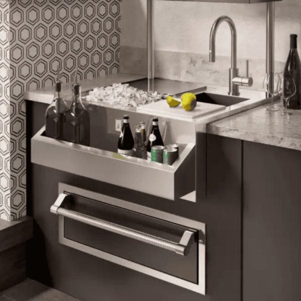 Modern kitchen sink with integrated beverage cooler, featuring bottles and cans, surrounded by stylish hexagonal patterned backsplash and elegant countertop.