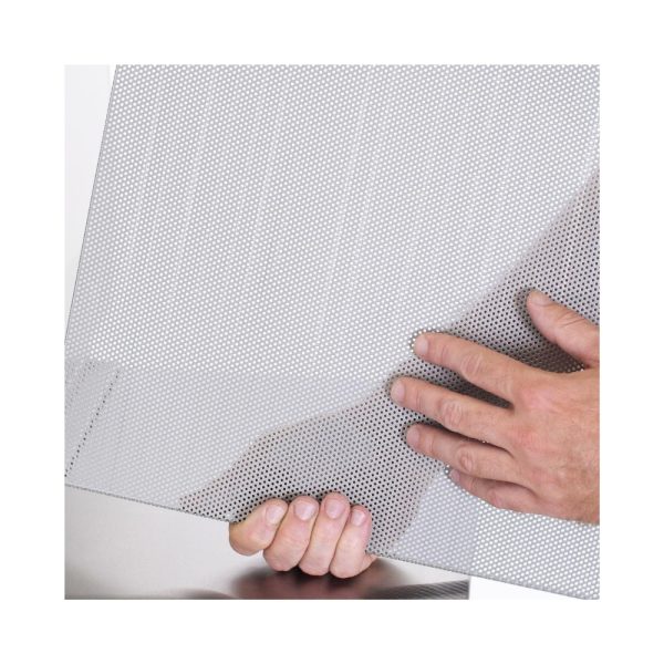 Person holding a sheet of perforated metal, showcasing its texture and design.