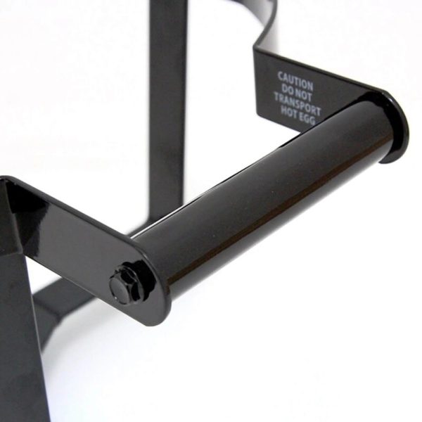 Black metal egg holder with a caution label warning against transporting hot eggs, showcasing its sturdy design and functionality.
